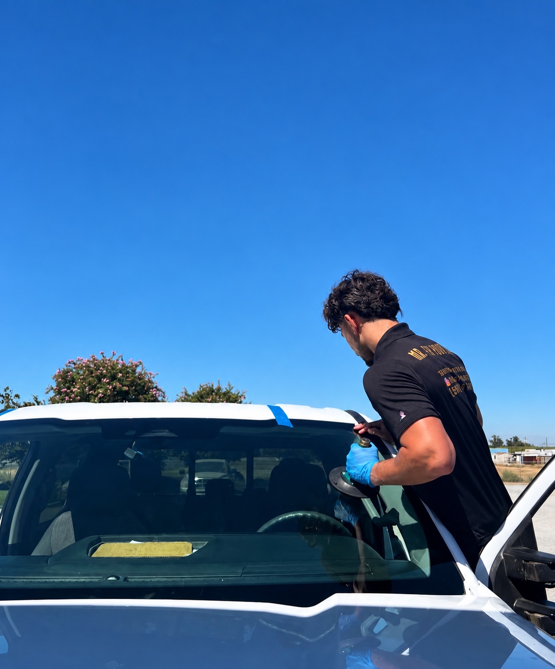 Technician completing windshield installation work