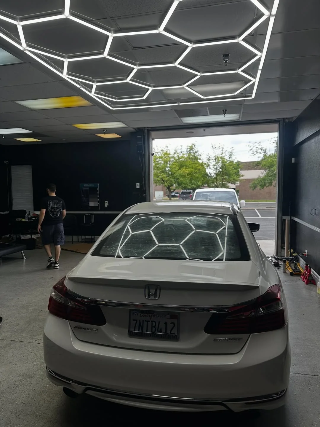 White Honda sedan in the Mr. Fix Your Chip shop bay after glass service