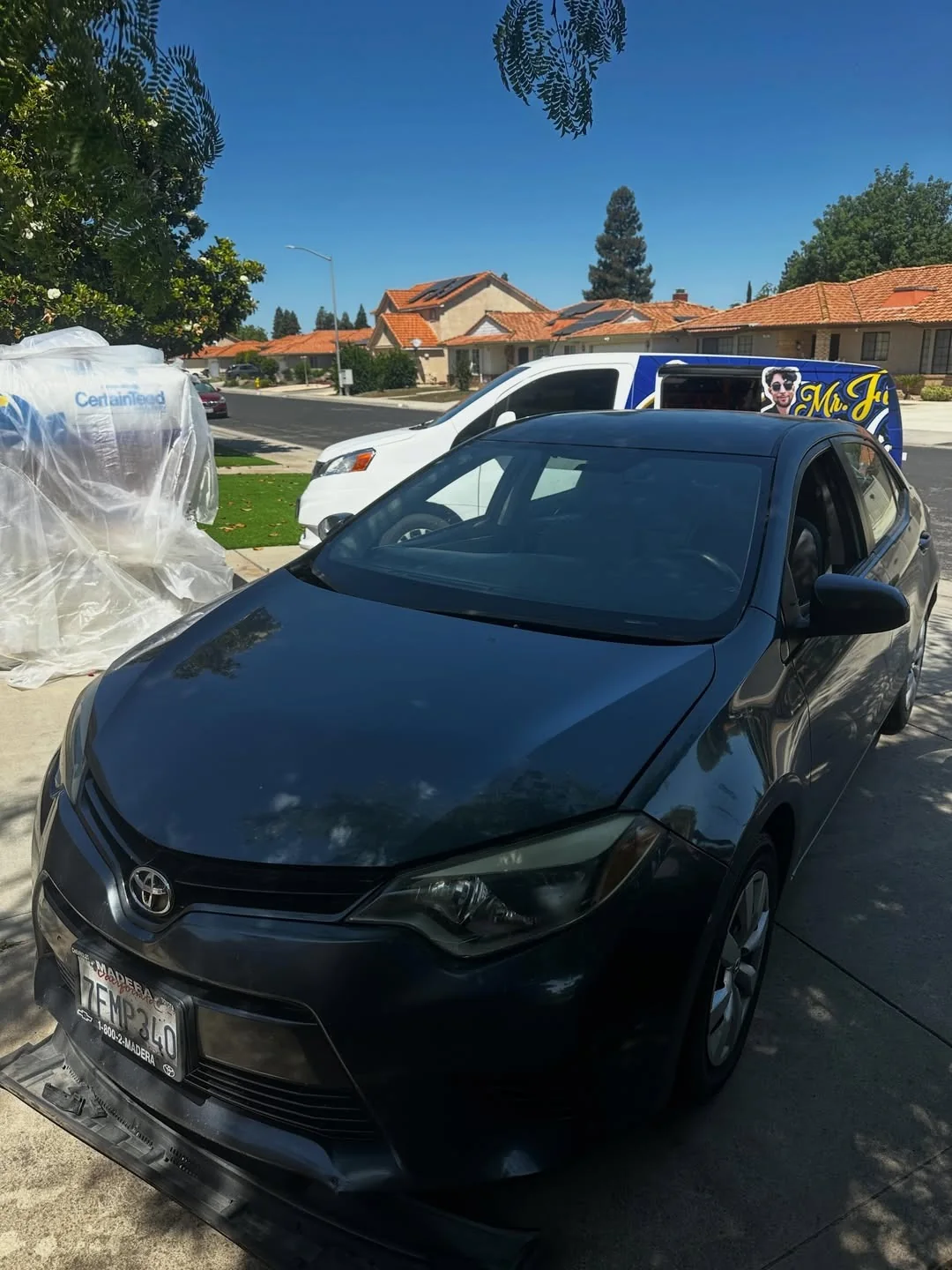 Sedan with the mobile service van at a residential appointment